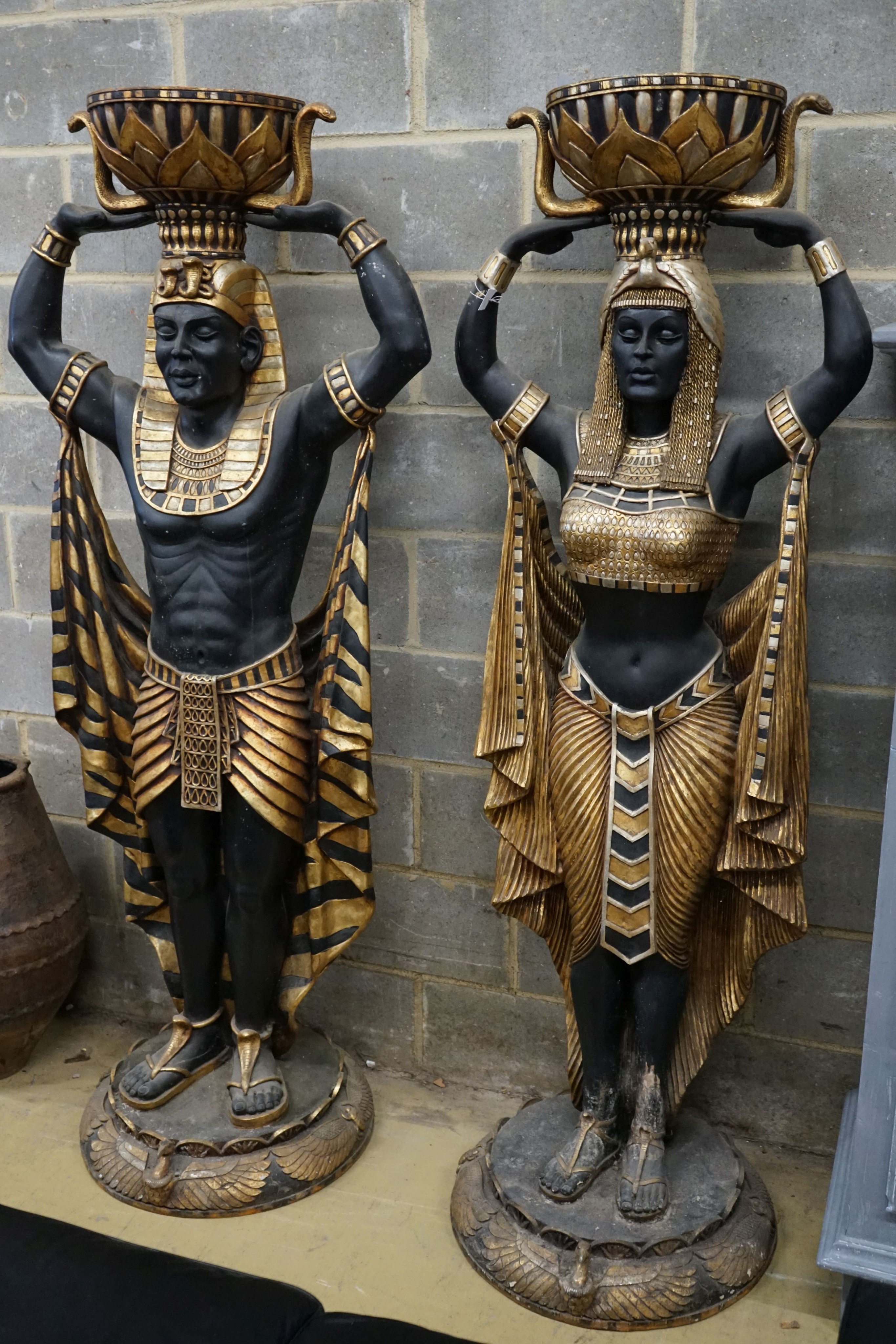 A pair of composition Egyptian style figural planters, height 185cm